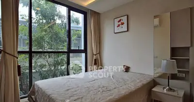 Cozy bedroom with large window and modern decor