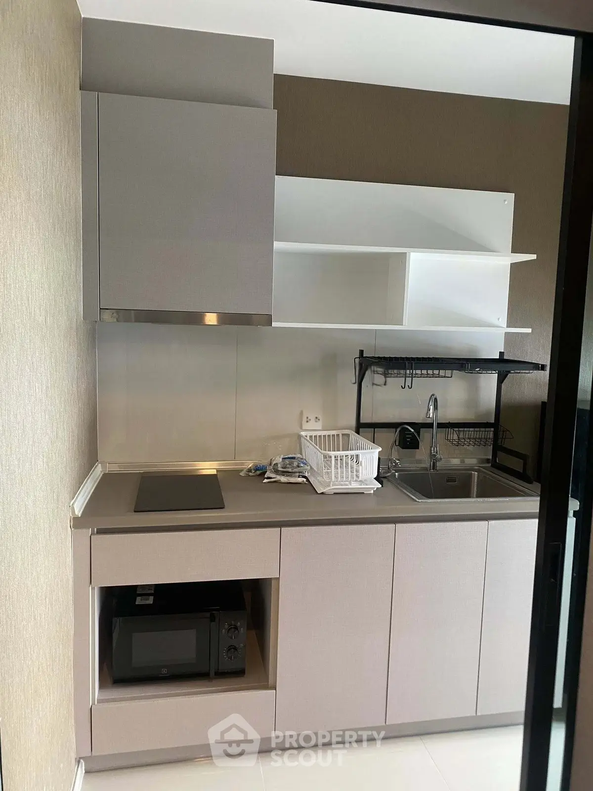 Modern compact kitchen with sleek cabinetry and built-in appliances, perfect for urban living.