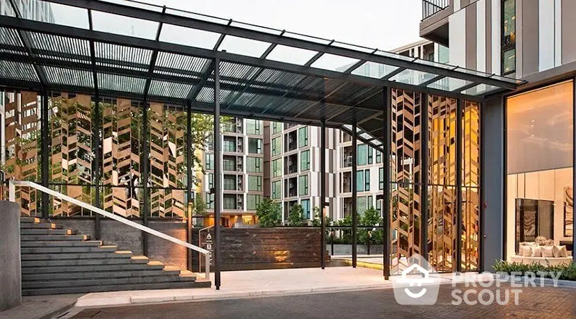 Modern apartment building entrance with stylish glass and metal design