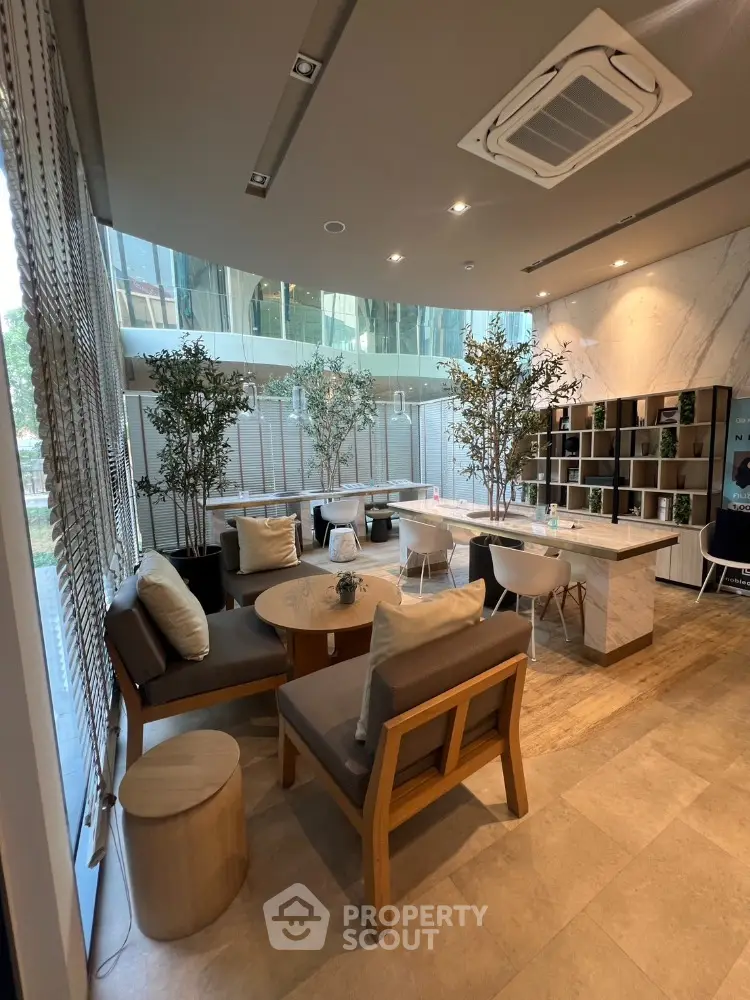 Modern lounge area with stylish furniture and large windows in a luxury building