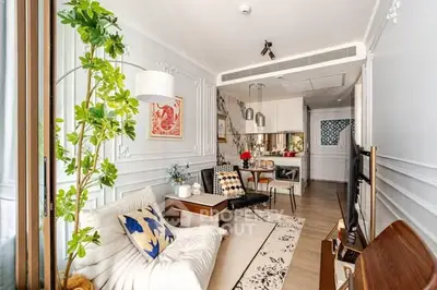 Chic modern living room with stylish decor and open kitchen layout in a cozy apartment.
