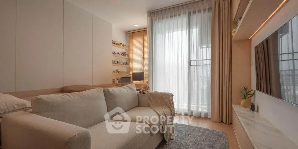 Cozy living room with modern decor and large window for natural light.