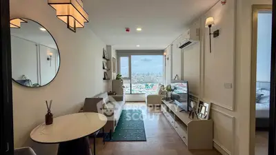 Modern living room with city view, stylish decor, and natural light