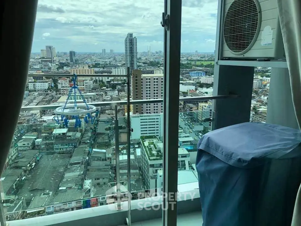 Stunning cityscape view from high-rise balcony with air conditioning unit.