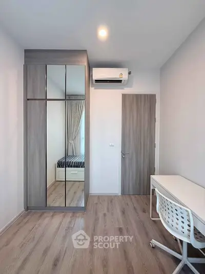 Modern bedroom with mirrored wardrobe and study desk in minimalist design