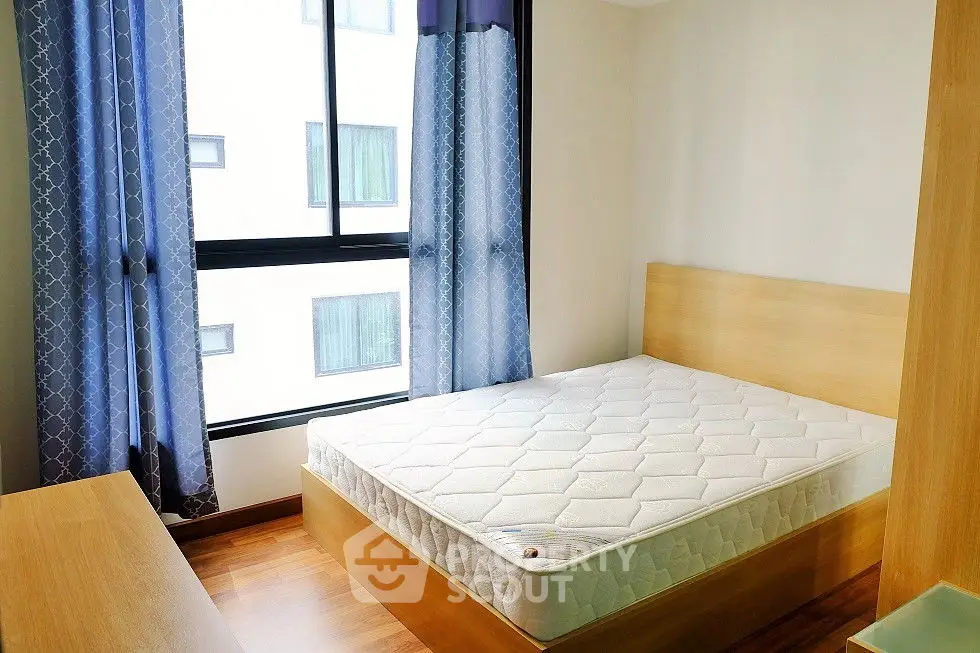 Bright bedroom with large windows and modern decor