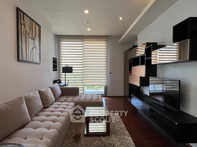 Modern living room with stylish furniture and large windows offering natural light.