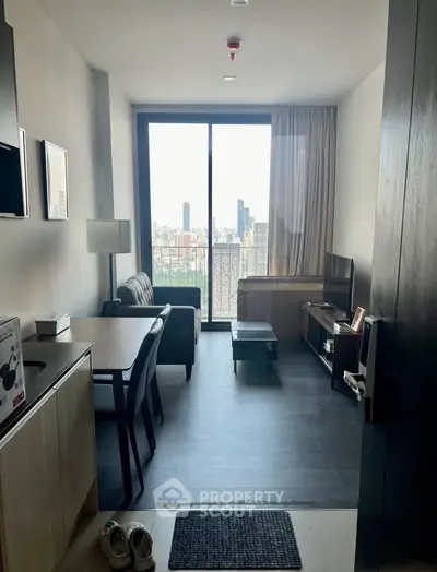 Modern living room with city view, stylish furniture, and large window for natural light.