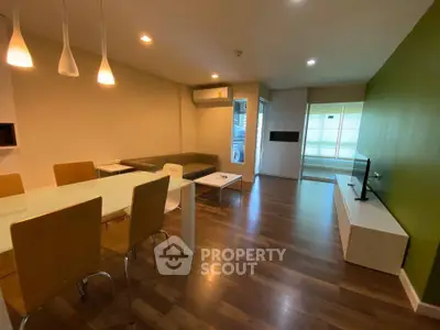 Spacious modern living room with dining area and stylish lighting in a contemporary apartment.
