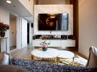 Luxurious modern living room with stylish decor and large wall-mounted TV, perfect for entertainment.
