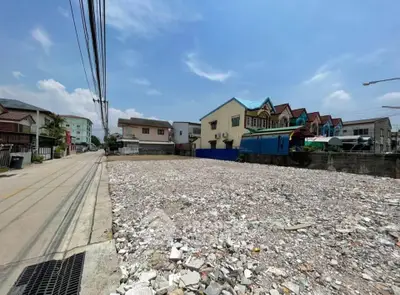 Vacant land plot in residential area with clear blue sky