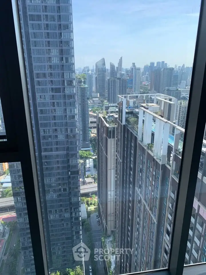 Stunning cityscape view from high-rise apartment window showcasing modern urban skyline.