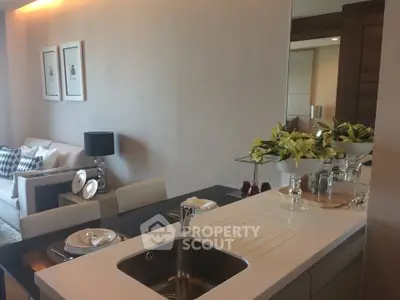 Modern open-layout kitchen with sleek design and elegant dining area in a stylish apartment.