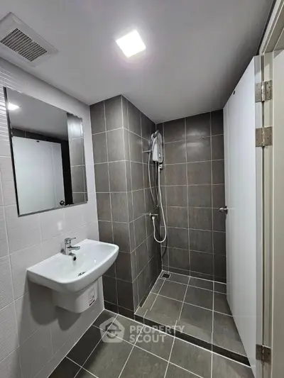 Modern bathroom with sleek tiles and walk-in shower design