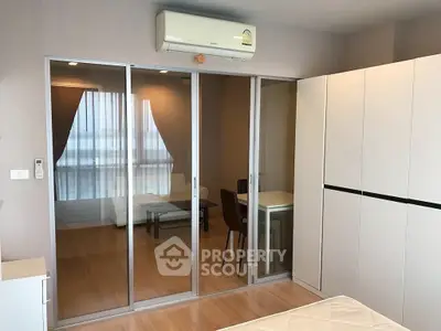 Modern bedroom with sliding glass doors and air conditioning in a stylish apartment.