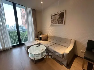 Modern living room with city view, featuring stylish sofa and glass coffee table.
