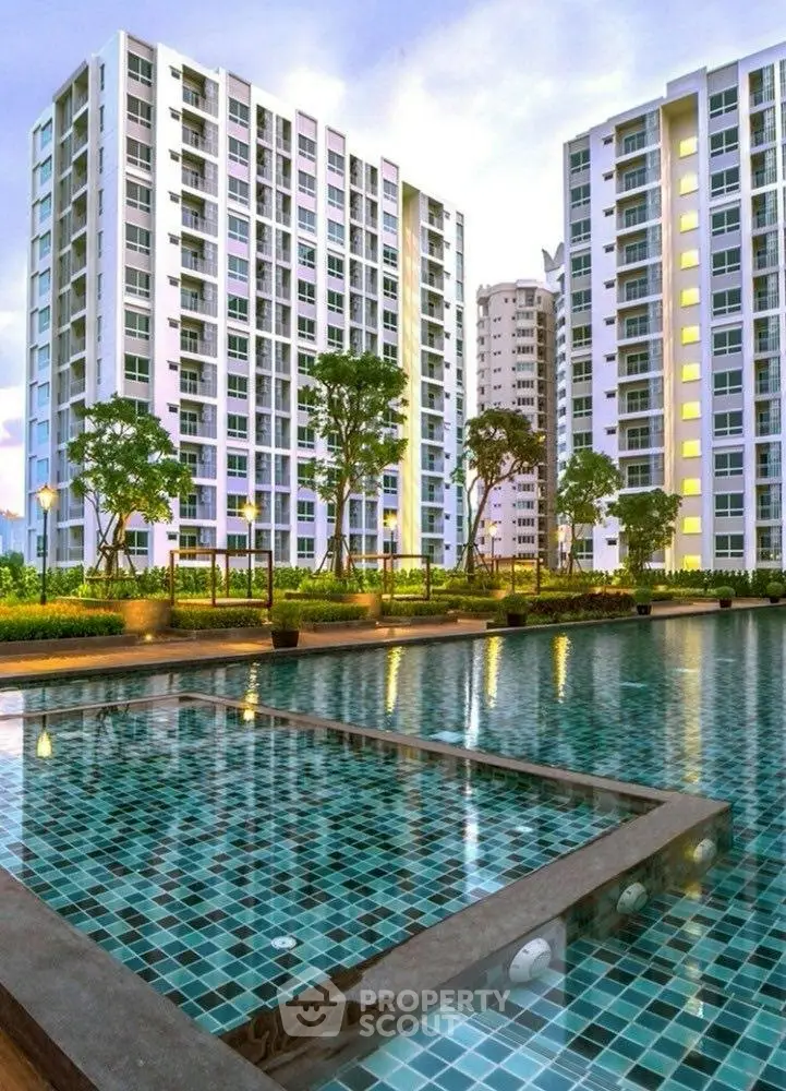 Luxurious high-rise apartments with stunning pool view and lush greenery.