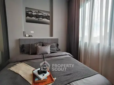 Cozy bedroom with modern decor and natural light from large window