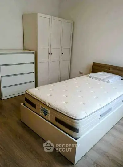 Cozy bedroom with minimalist furniture and comfortable bed