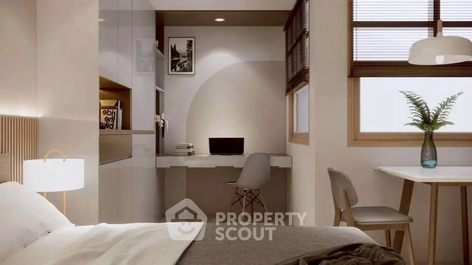 Modern bedroom with study area, featuring sleek furniture and natural light.