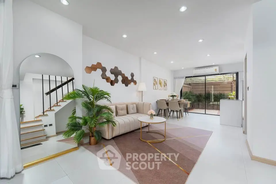 Spacious modern living room with elegant decor and open dining area.