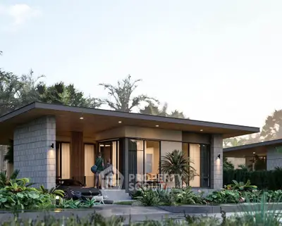 Modern single-story home with lush landscaping and sleek architectural design.
