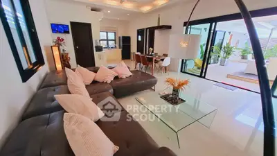 Luxurious open-plan living room with modern decor and sliding glass doors to patio.