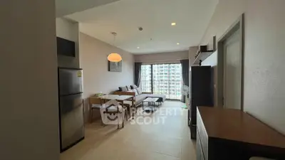 Modern living room with dining area and large window view in a stylish apartment.