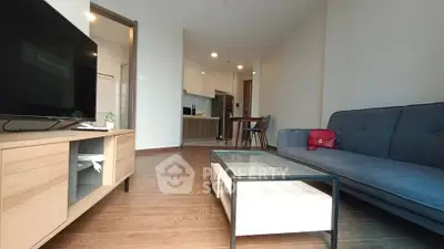 Modern living room with stylish furniture and open kitchen layout