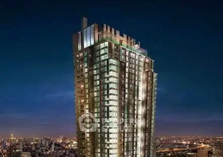 Stunning high-rise building with cityscape view at night, showcasing modern architecture.