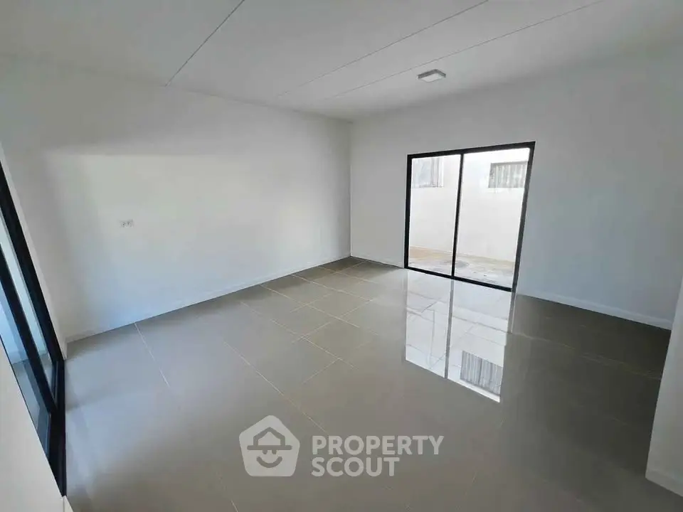 Spacious empty room with large windows and glossy tiled floor, perfect for customization.