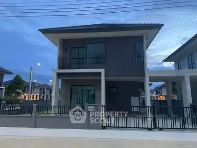 Modern two-story house with sleek design and spacious driveway in a serene neighborhood.