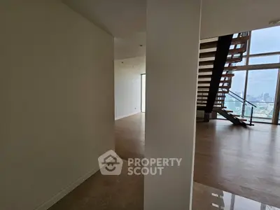 Spacious modern living room with wooden flooring and city view