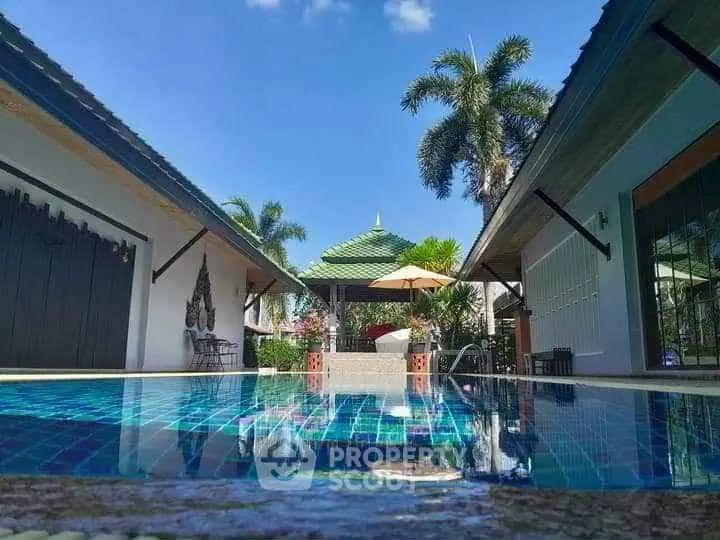 Stunning tropical villa with private pool and lush garden, perfect for luxurious relaxation.