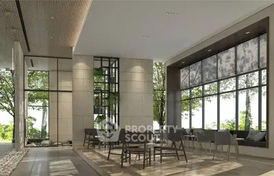 Modern interior with stylish seating and large windows overlooking greenery.