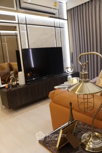 Luxurious living room with modern decor, featuring a sleek TV unit and elegant lighting.