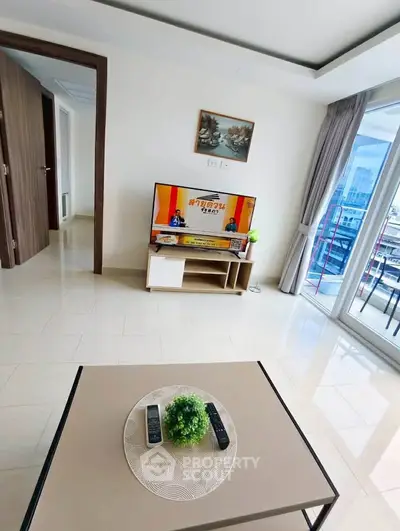 Modern living room with TV and balcony view in a stylish apartment