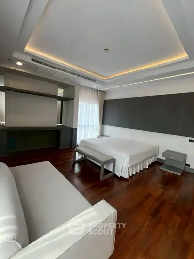 Luxurious modern bedroom with elegant wooden flooring and ambient lighting