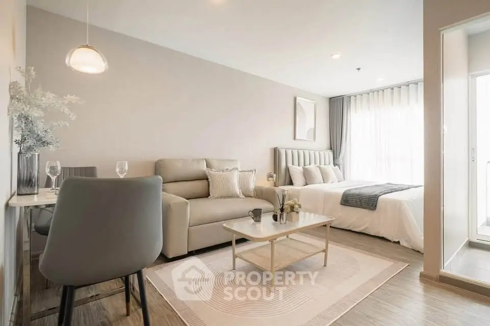 Modern studio apartment with cozy living area and elegant bedroom, featuring stylish decor and natural light.