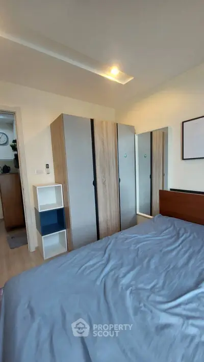Modern bedroom with stylish wardrobe and cozy bed in a contemporary apartment.