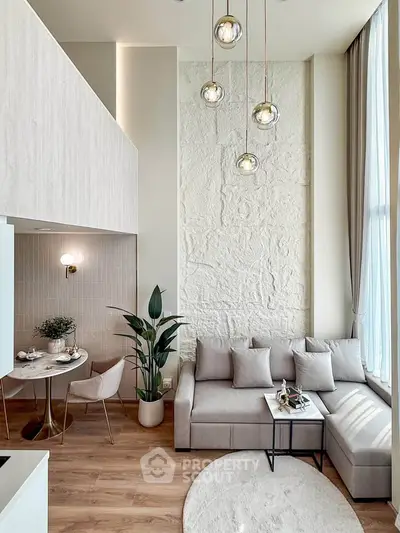 Modern living room with high ceilings, stylish decor, and natural light