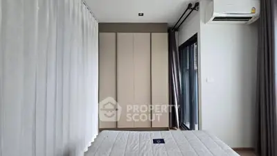 Modern bedroom with sleek wardrobe and large window for natural light