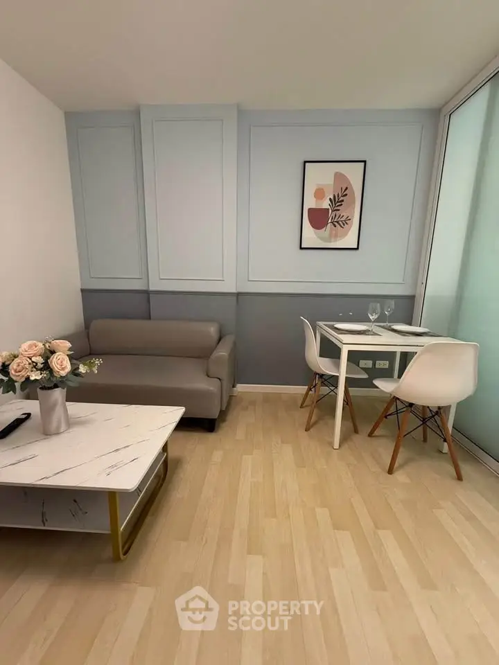 Modern living room with stylish decor and dining area, featuring a cozy sofa and elegant table setting.