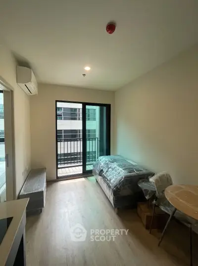 Cozy modern living room with balcony access in a stylish apartment