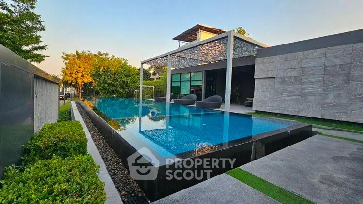 Luxurious modern home with stunning infinity pool and lush greenery