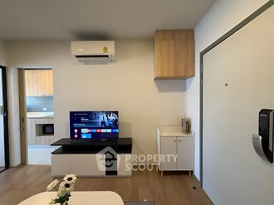 Modern living room with sleek TV setup and air conditioning in stylish apartment.