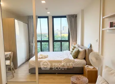 Modern bedroom with large windows and scenic view in a stylish apartment