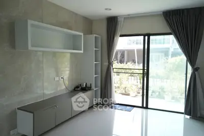 Modern living room with large windows and sleek built-in storage