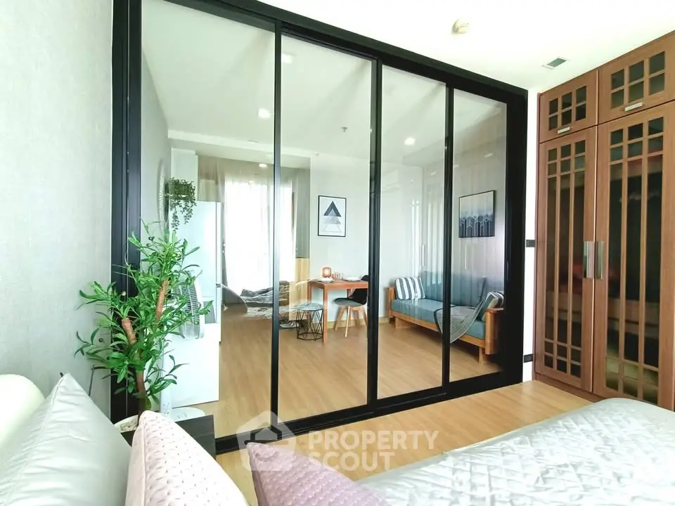 Spacious modern living room with sliding glass doors and elegant wooden flooring.