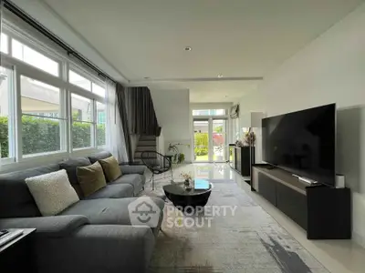 Spacious modern living room with large windows and stylish decor